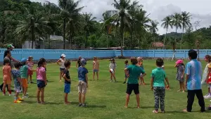 Children engaging in play on the field, promoting teamwork and outdoor activity.