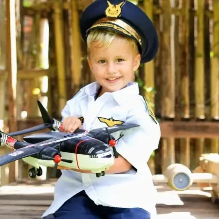 A child wearing a pilot uniform holding a miniature airplane, expressing dreams of aviation