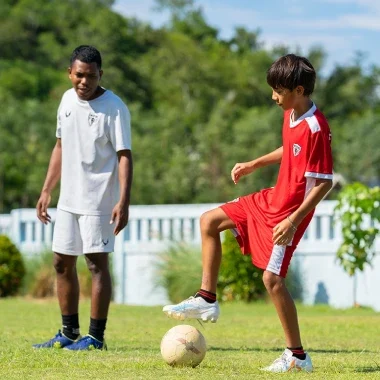 Children fully engaged in playing soccer, demonstrating teamwork and concentration.