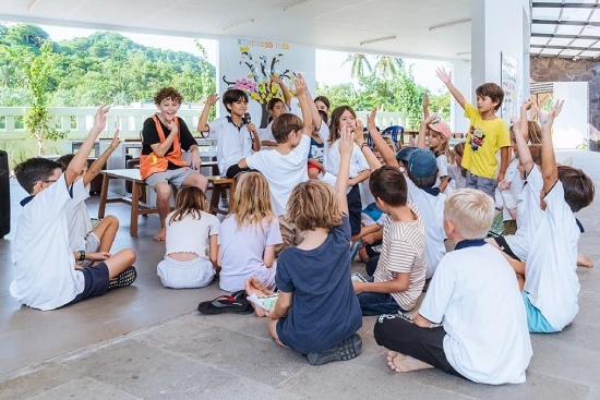 Child actively participating in a learning environment by answering questions.