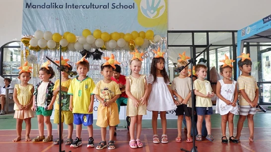 Several children confidently performing in front of an audience.