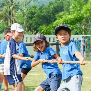 Demonstrating teamwork and strength in a fun outdoor activity.