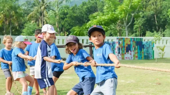 Demonstrating teamwork and strength in a fun outdoor activity.