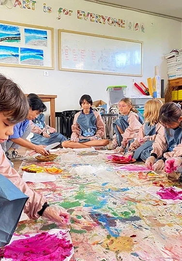 Children enhancing their creativity by coloring using fruits as inspiration or tools.