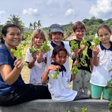 Children participating in gardening activities, learning and collaborating in nature.