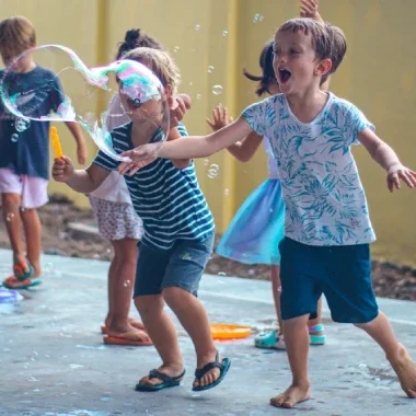 Joyfully playing with blow-up balloons.