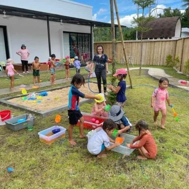 Tossing and bursting them while enjoying a playful outdoor activity.